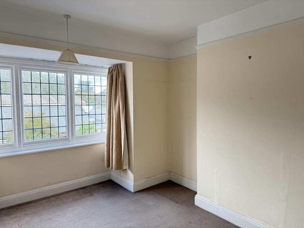 Lot: 106 - THREE-BEDROOM HOUSE IN NEED OF IMPROVEMENT - Bedroom one with magnolia walls and beige carpet